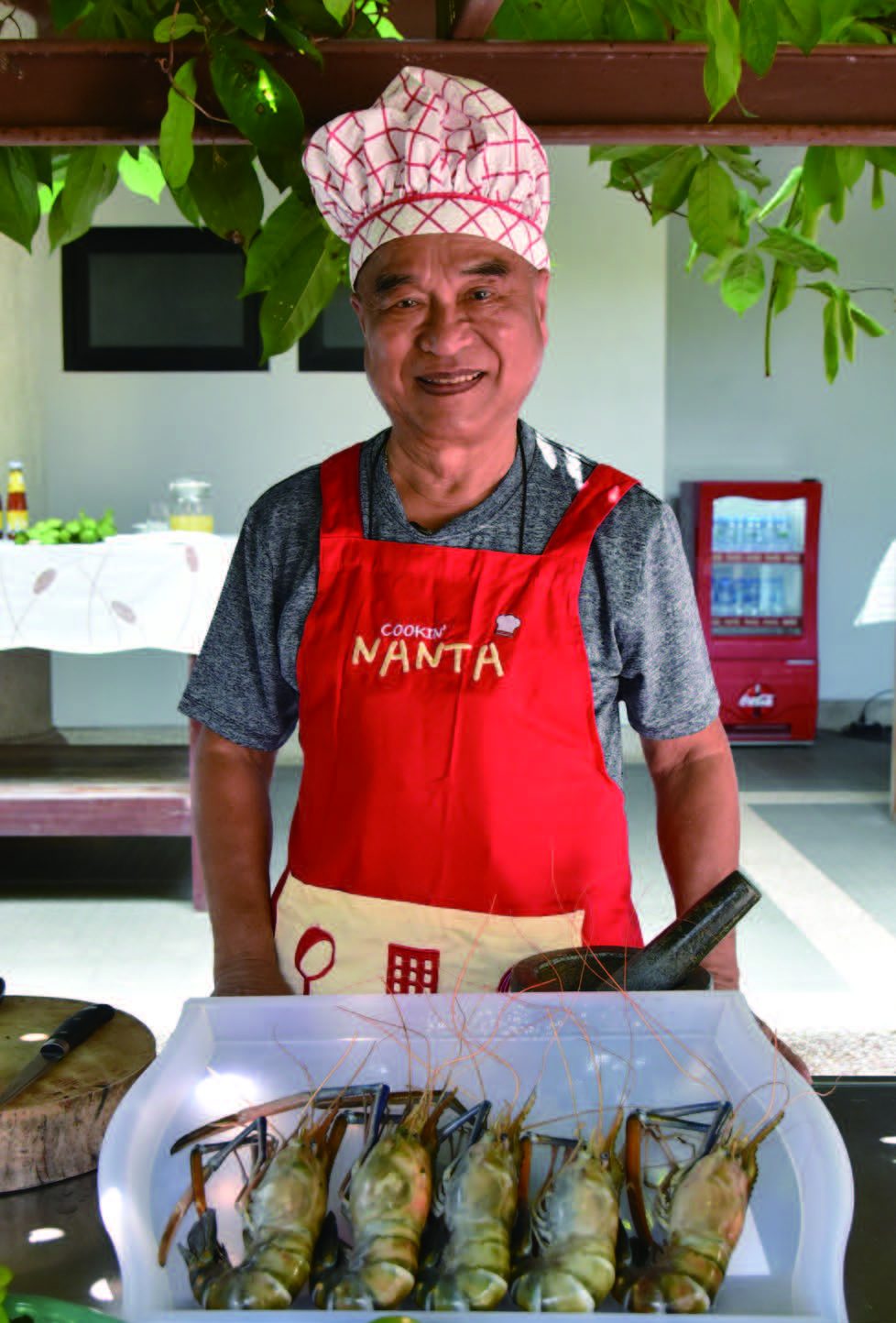 Dr. Taweep, MD, demonstrating the preparation of Tomyum Kung using a variety of healthy herbs. © Department of Cultural Promotion, Thailand