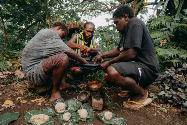 Mr Wahe with community members preparing food for preservation © Senolita Fonokalafi, Jean Pascale Wahe